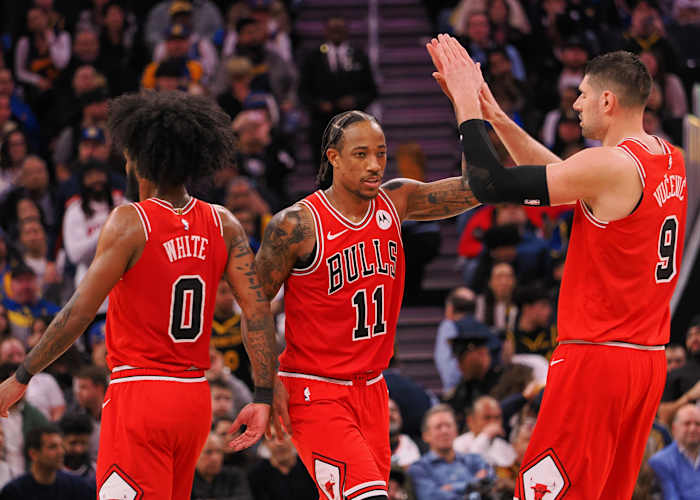 Chicago Bulls forward DeMar DeRozan (11) high fives guard Coby White (0) and center Nikola Vucevic (9) after a play against the Golden State Warriors during the fourth quarter at Chase Center.